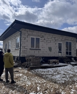 Люди смотрят на дом из газобетона