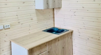 Каркасная баня длиной 7 м с верандой и отделкой из дерева