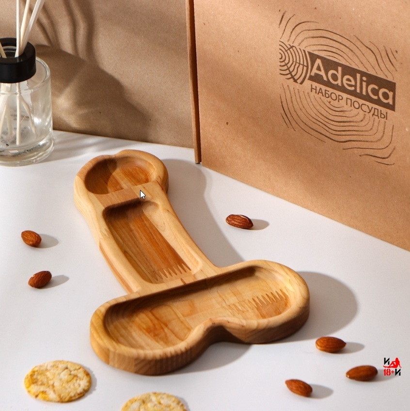 На фотографии изображено деревянное блюдо в виде пениса